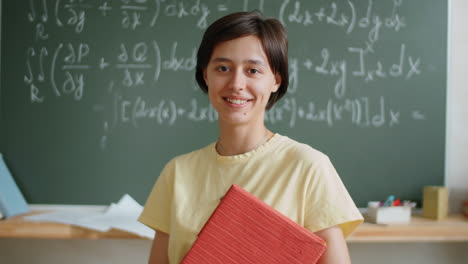Portrait-of-Cheerful-Female-Student-in-Classroom